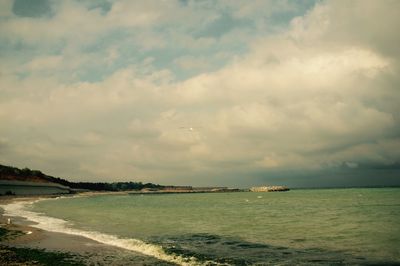Scenic view of sea against cloudy sky