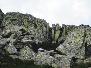 Low angle view of rocks against sky