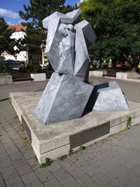 Close-up of statue in cemetery against sky