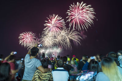 Low angle view of firework display at night