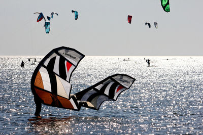 People kiteboarding in sea