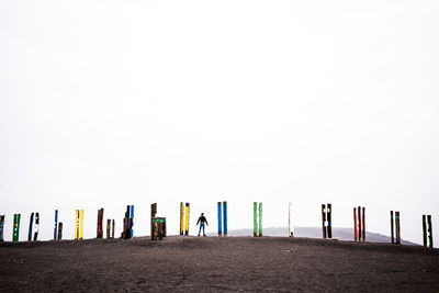 People on beach against clear sky