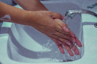 Midsection of woman in bathroom at home