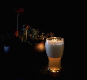 Close-up of drink on table against black background