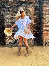 Full length of woman standing against brick wall