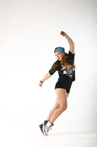Full length of young woman against white background