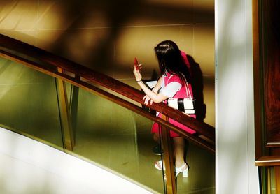 Rear view of woman walking in stairs