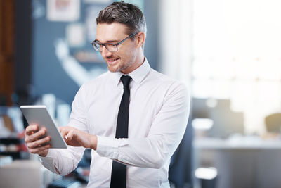 Businessman using mobile phone at office