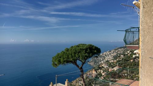 Scenic view of sea by building against sky