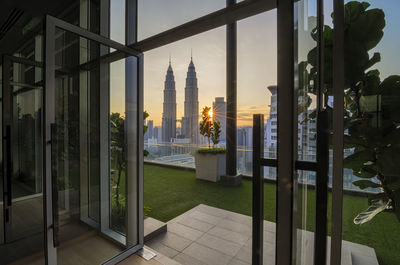 Petronas towers in city seen through doorway