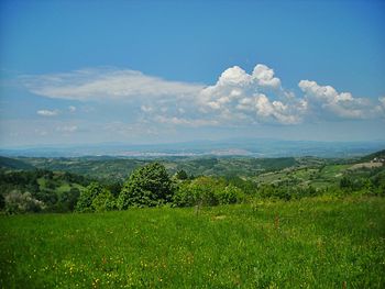 Scenic view of landscape against cloudy sky
