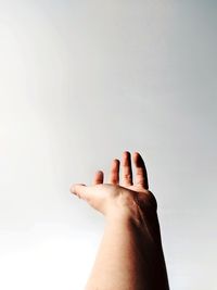 Cropped hand against white background