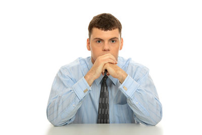Portrait of young man against white background