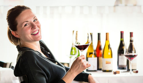 Portrait of smiling woman holding drink