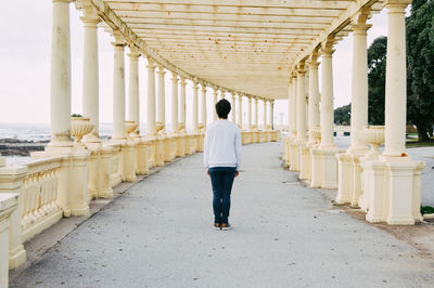 Rear view of people walking in corridor