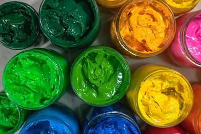 High angle view of multi colored candies in glass