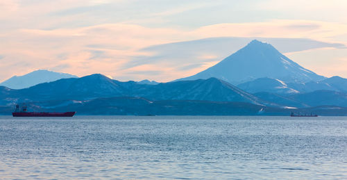 The fishing boats in the bay with the volcano on kamchatka