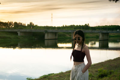 Portrait of woman standing against sky