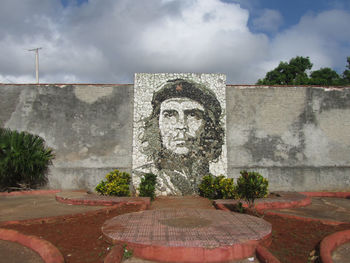 Statue of historical building against cloudy sky