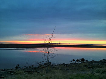 Scenic view of lake against cloudy sky