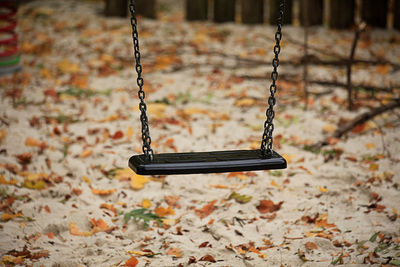 Close-up of empty swing in playground