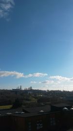 View of cityscape against blue sky