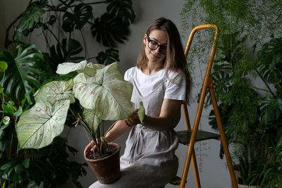 Full length of woman with potted plants