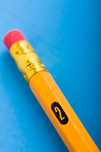 Close-up of colored pencils on blue table