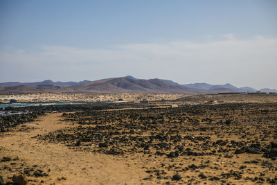 Scenic view of arid landscape against sky