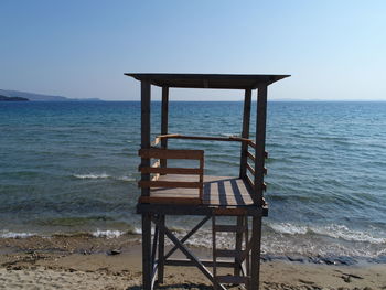 Lifeguard chair on beach against clear sky