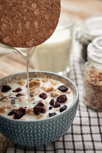 Morning breakfast with granola on wooden background