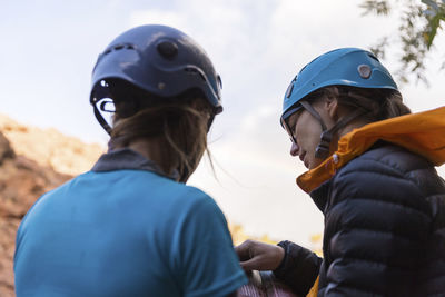 Hikers wearing helmets while reading guidebook