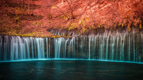 Scenic view of waterfall like white thread which multiple streaks of water drape