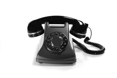 Close-up of telephone booth against white background