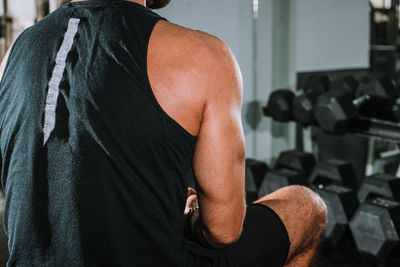 Rear view of man looking at camera