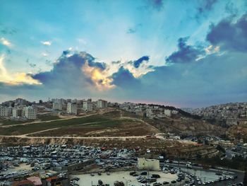 View of cityscape against cloudy sky