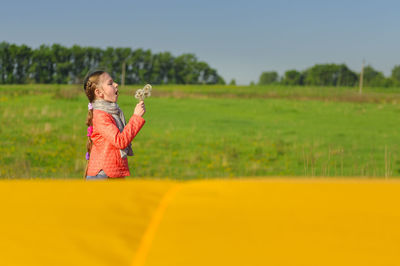 Full length of girl on field