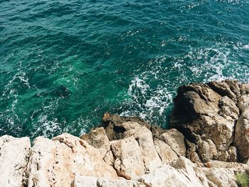 High angle view of rocks by sea