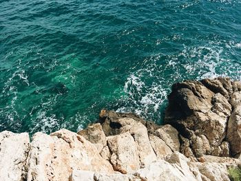 High angle view of rocks by sea