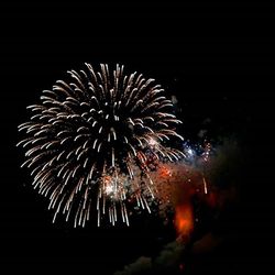 Low angle view of firework display at night