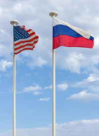 Low angle view of flags flag against sky