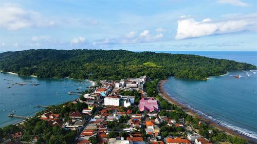 High angle view of townscape by sea against sky