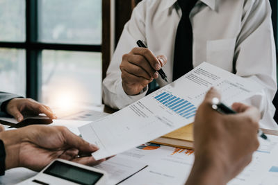 Midsection of business people working at office