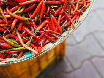 Close-up of red chili peppers in basket for sale