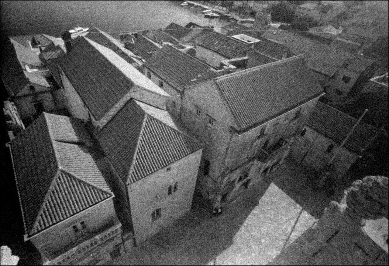 HIGH ANGLE VIEW OF STREET AMIDST BUILDINGS