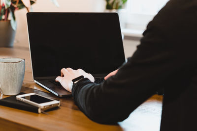 Midsection of man using mobile phone