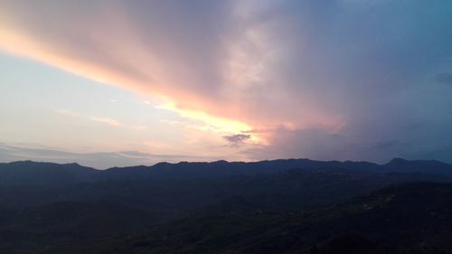 Scenic view of mountains against sky at sunset