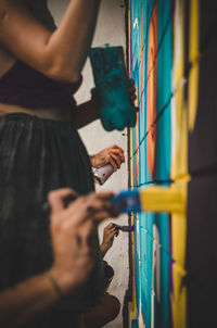 People painting wall at home