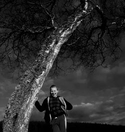 Full length of boy standing on field against sky