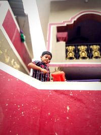 Boy playing drum at home